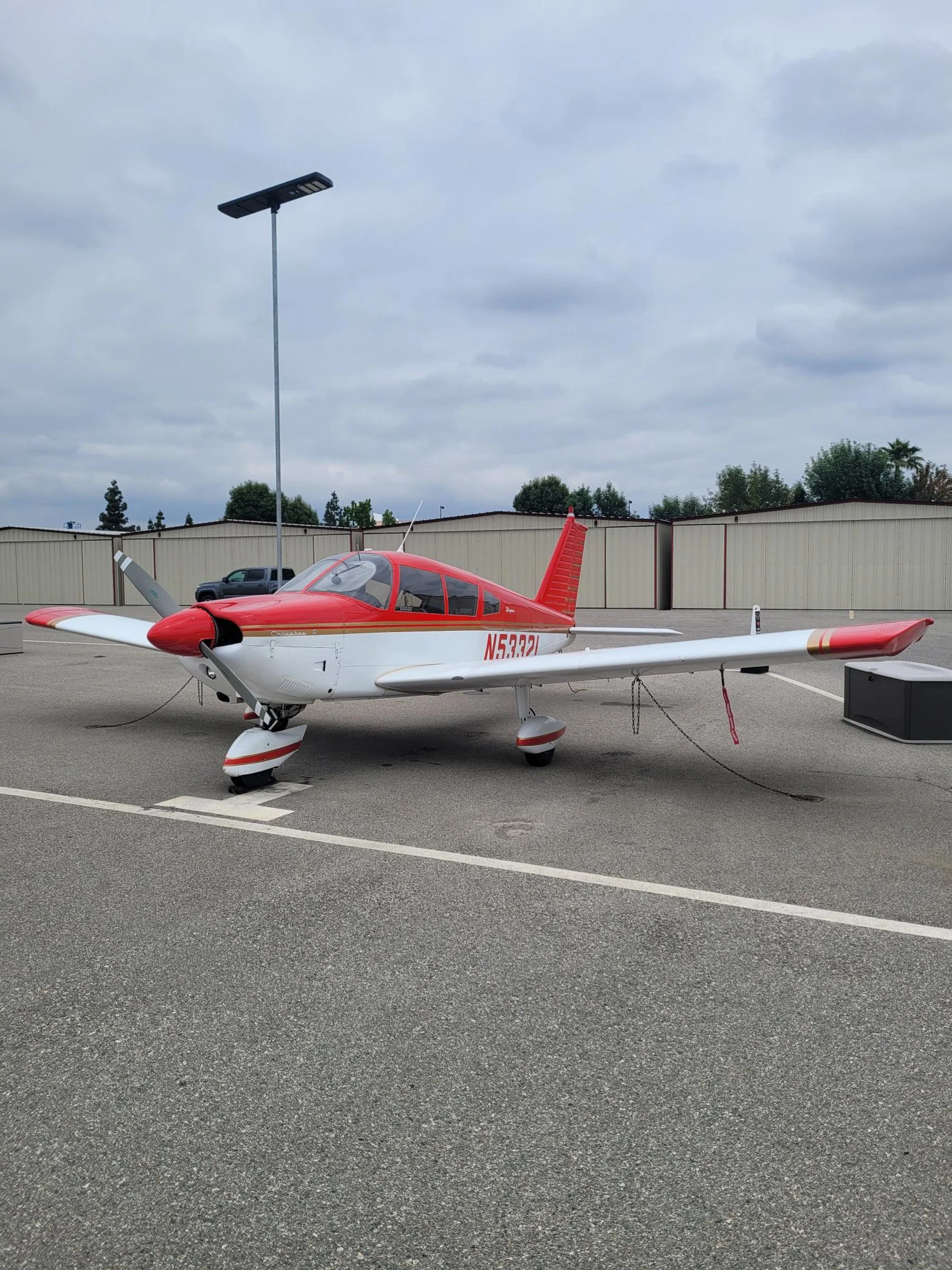 White Piper Cherokee 180 training airplane on the ramp